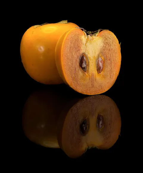 Cut persimmon fruit showing the interior flesh.